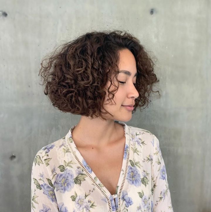 curly blunt bob with side bangs