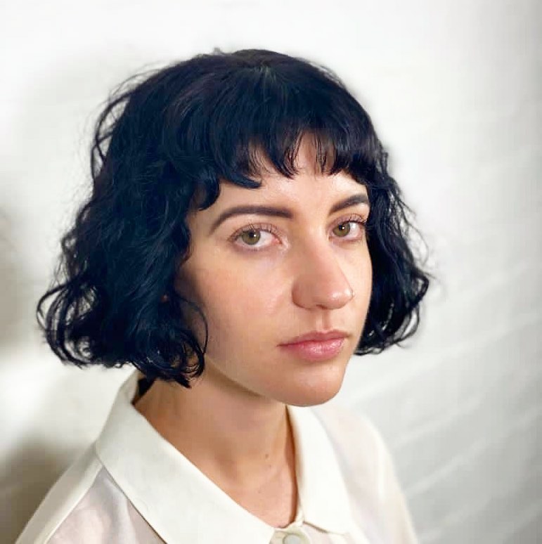 curly blunt bob with baby bangs