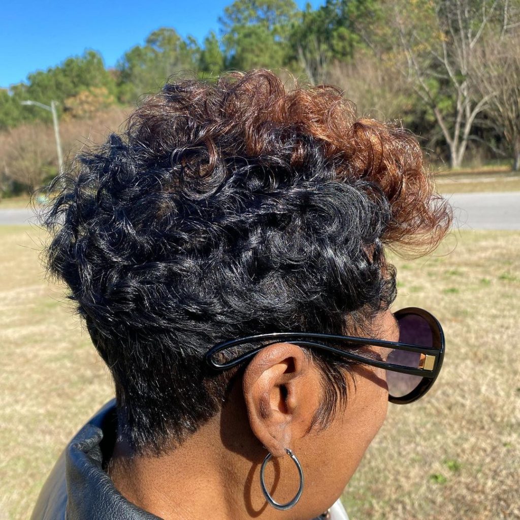 black curly pixie cut with brown bangs
