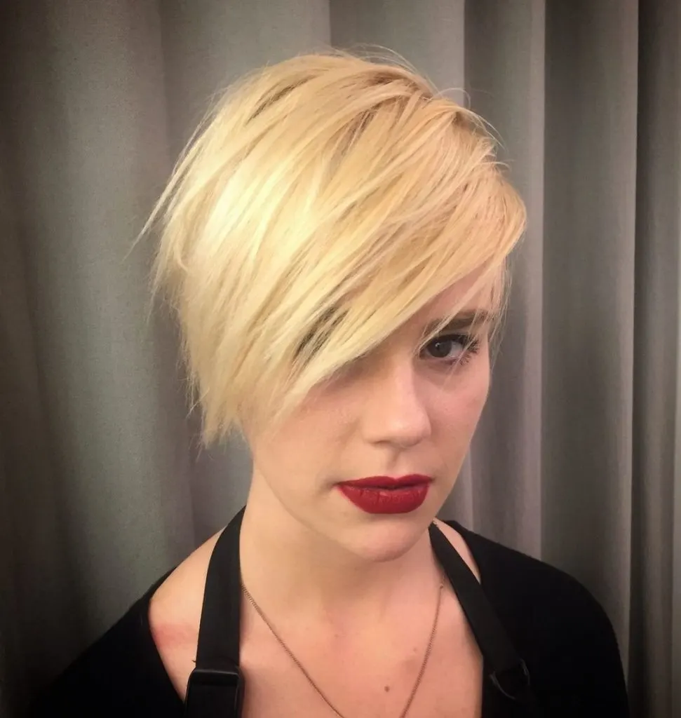 blonde pixie cut with eye covering bangs