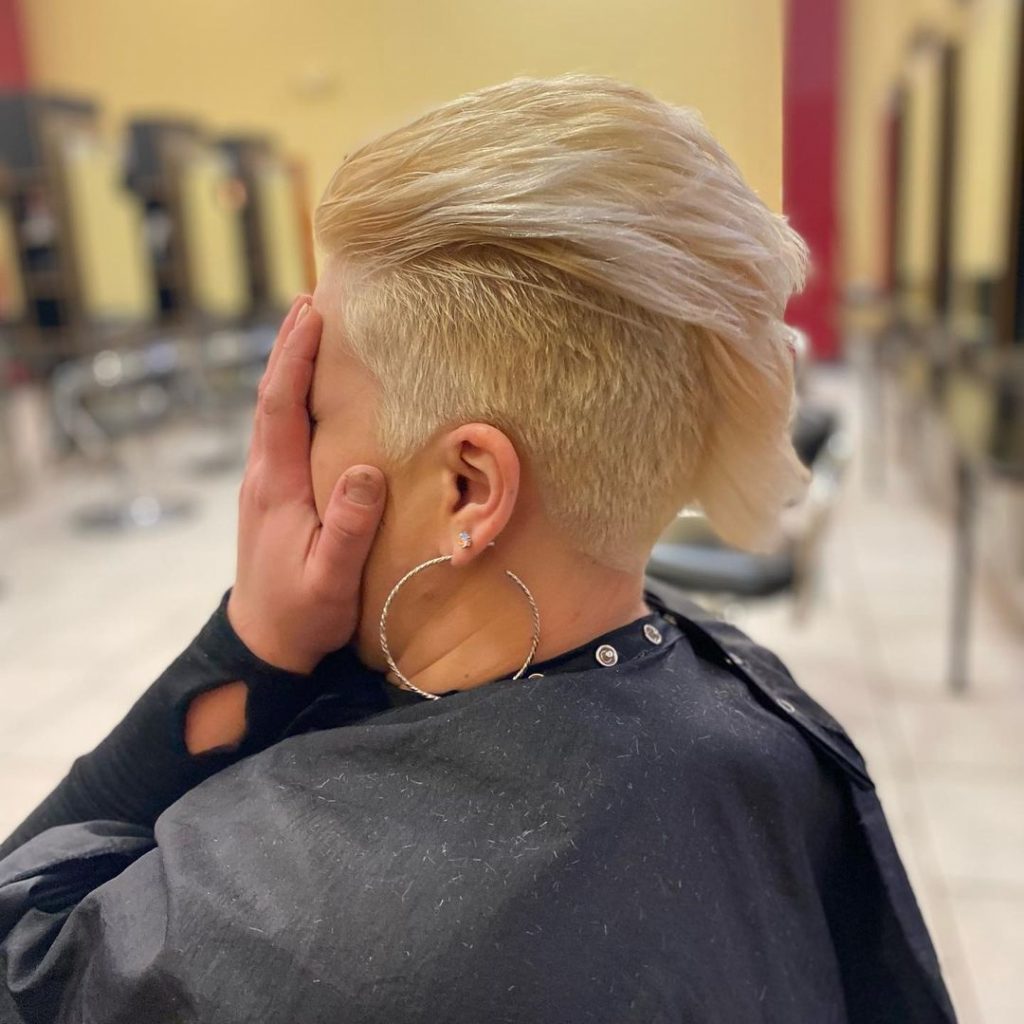 blonde pixie with faux hawk with shaved sides