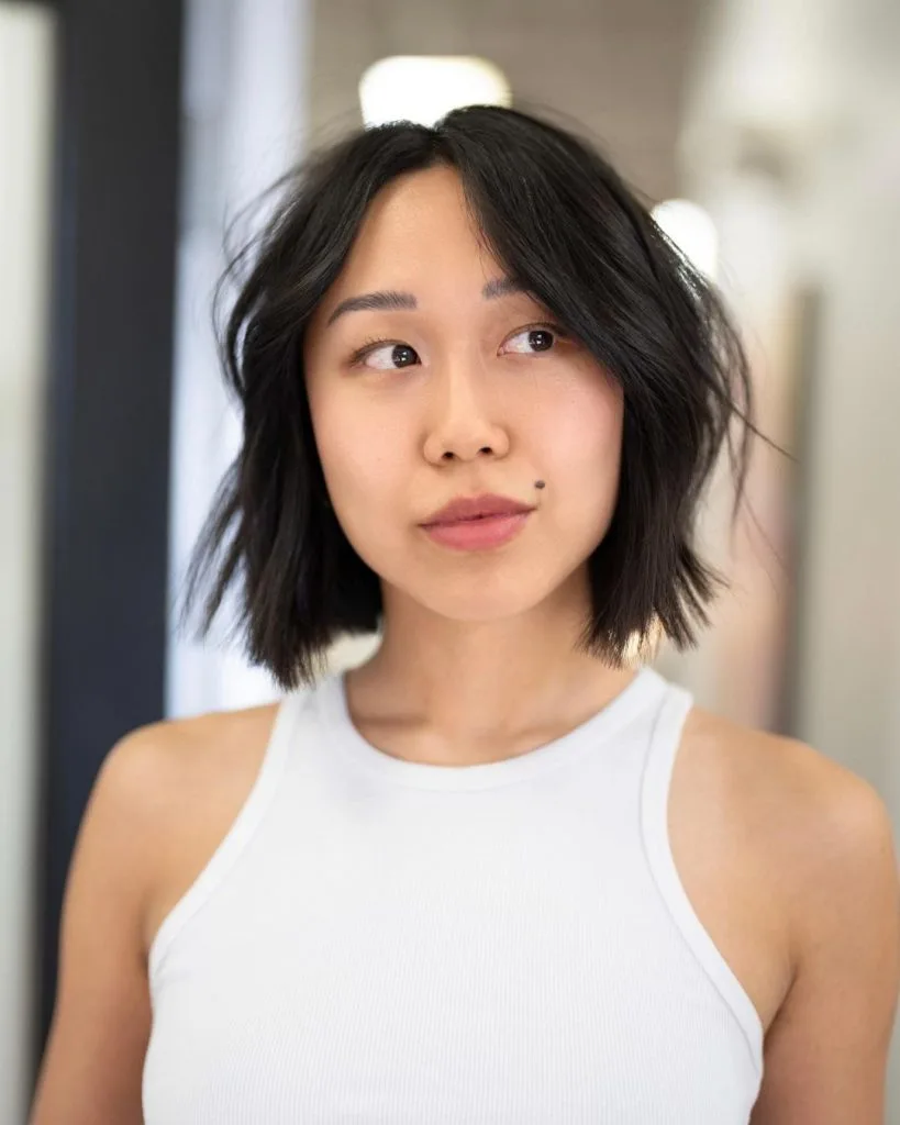 blunt cut choppy bob with long bangs