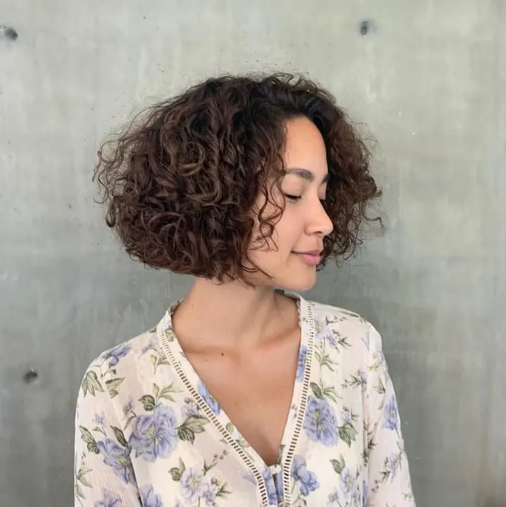 curly blunt bob with side bangs