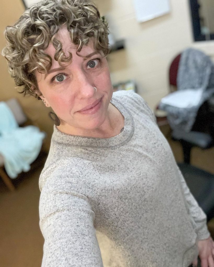 curly pixie cut with forehead bangs