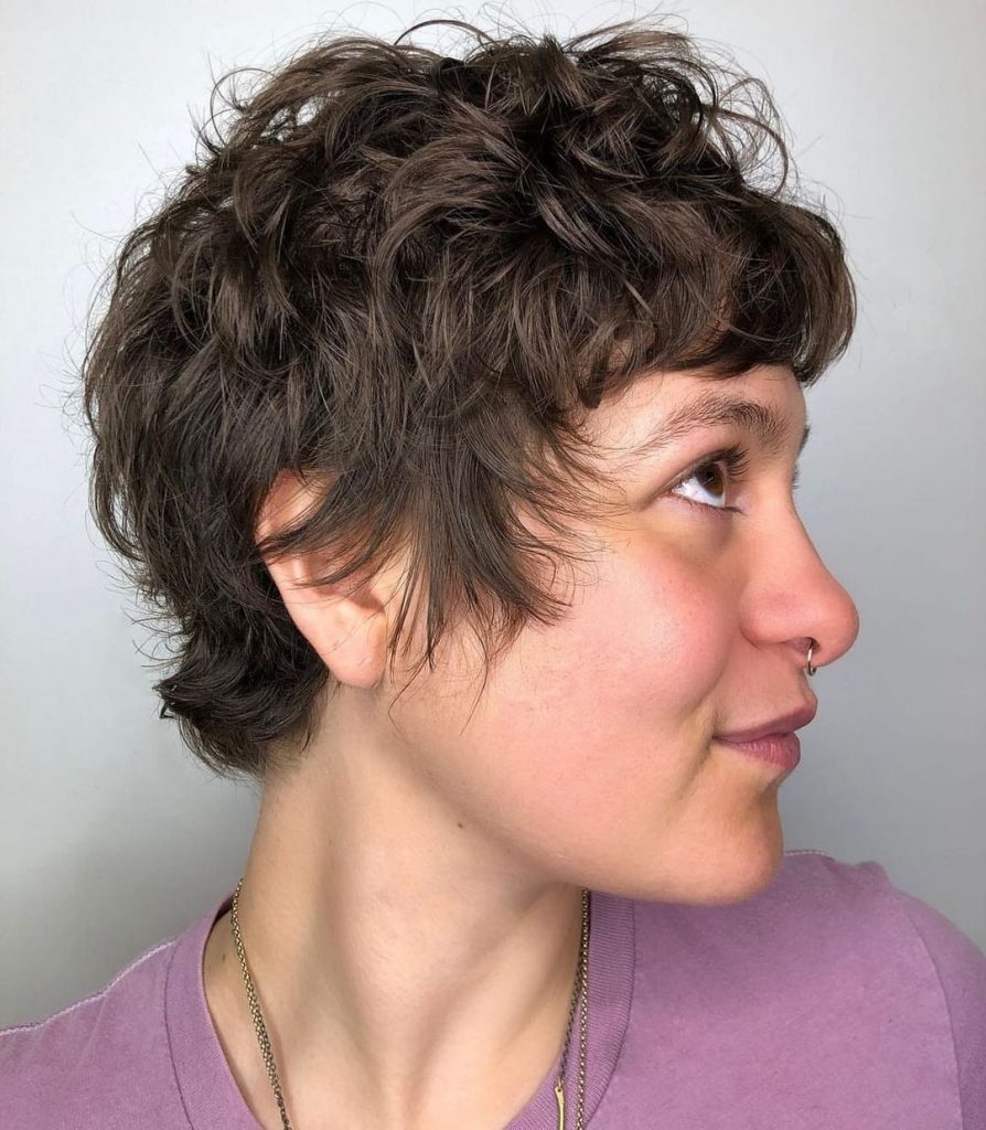 curly pixie cut with long sideburns