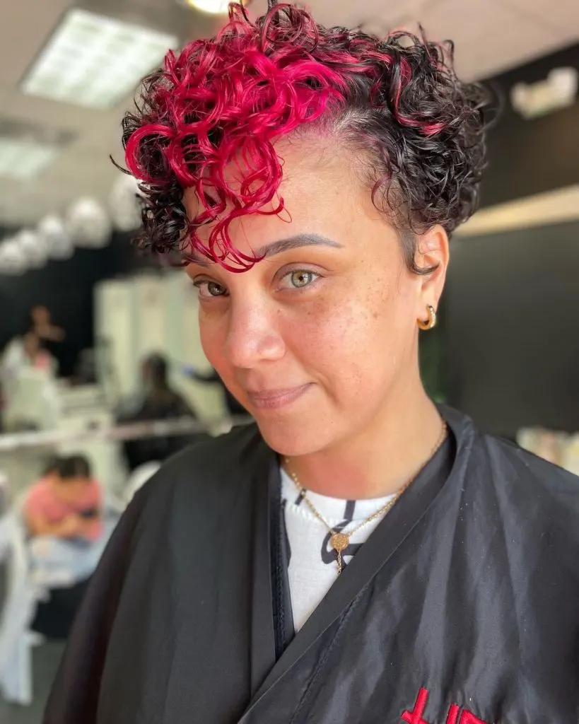 curly pixie cut with pink bangs