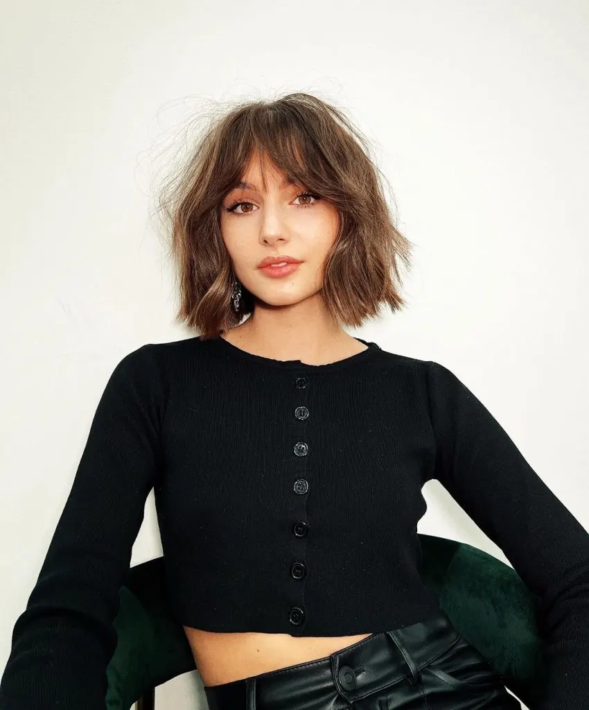 neck length blunt bob with curtain bangs