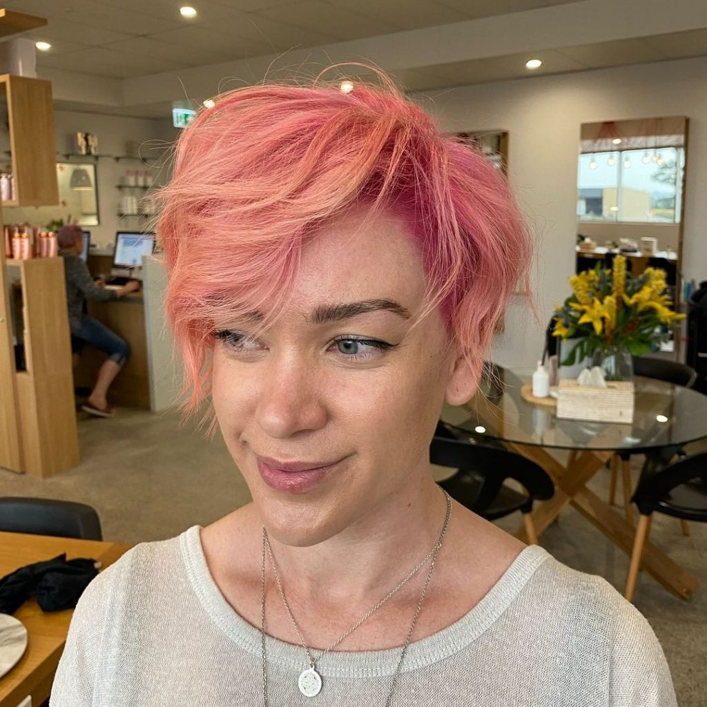 pastel pink pixie cut with curly bangs