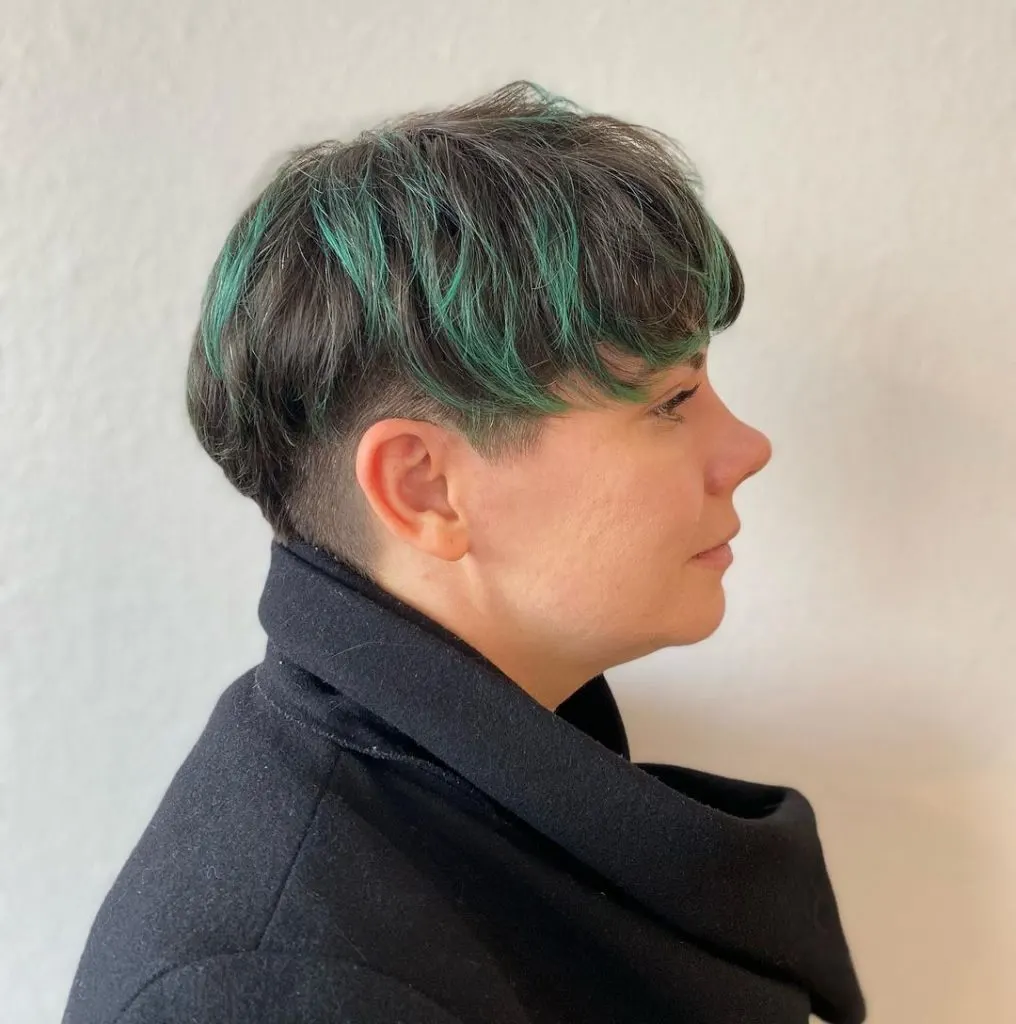 pixie cut with green highlights and shaved sides