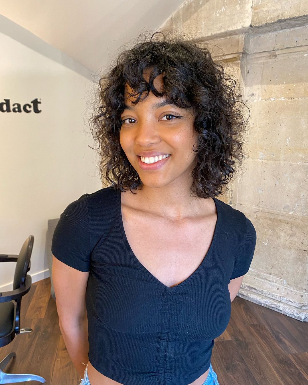 layered curly haircut with bangs