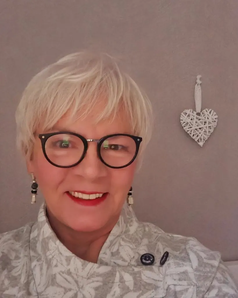 bleached blonde pixie cut for older ladies with glasses