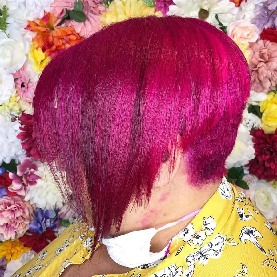 dark pink pixie cut with extra long bangs