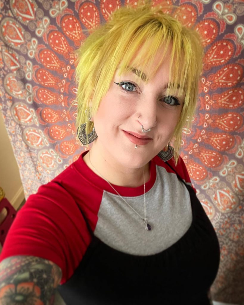 edgy bright yellow long pixie cut with bangs