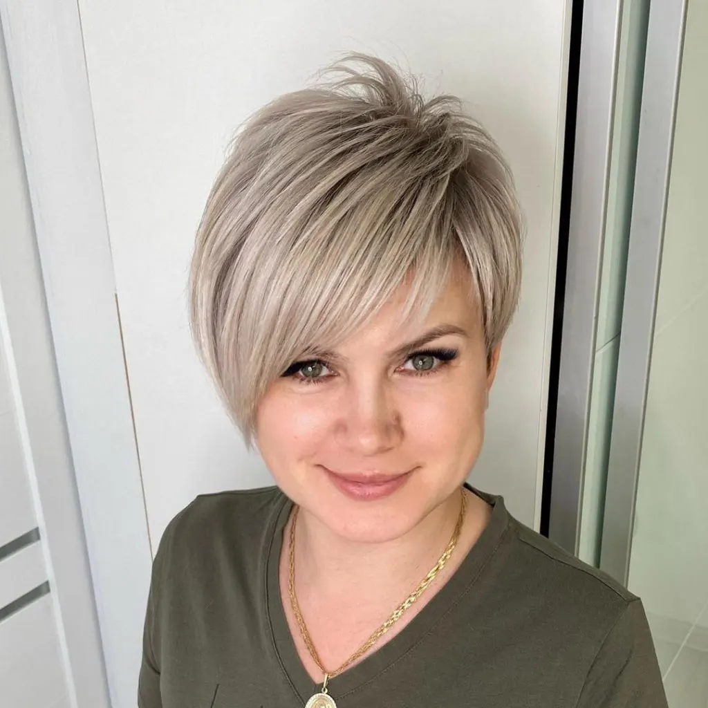 icy blonde long pixie cut with bangs
