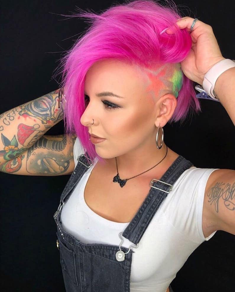 long vibrant pink pixie cut with tattooed undercut