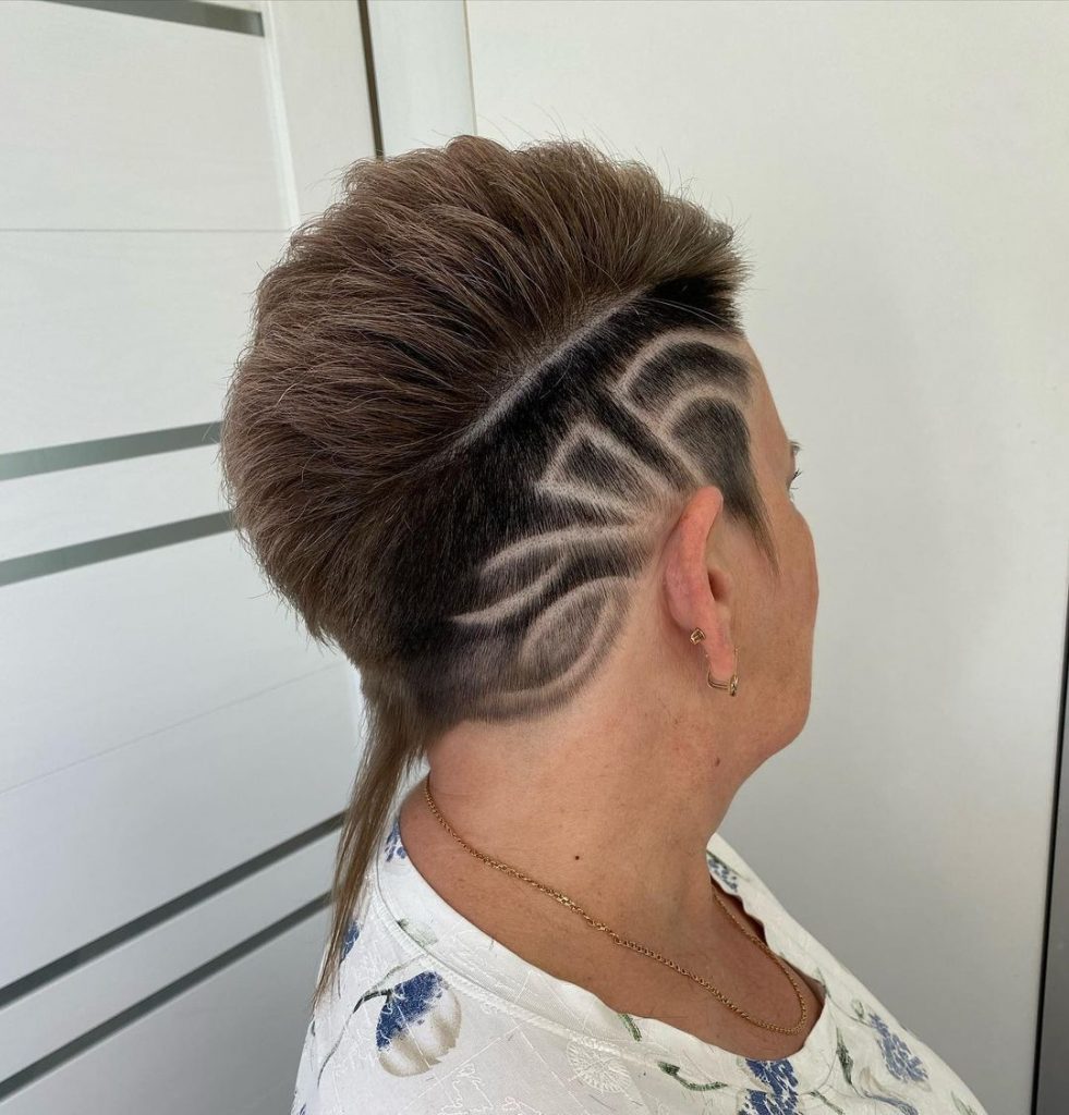 pixie cut with a rat tail and a patterned undercut