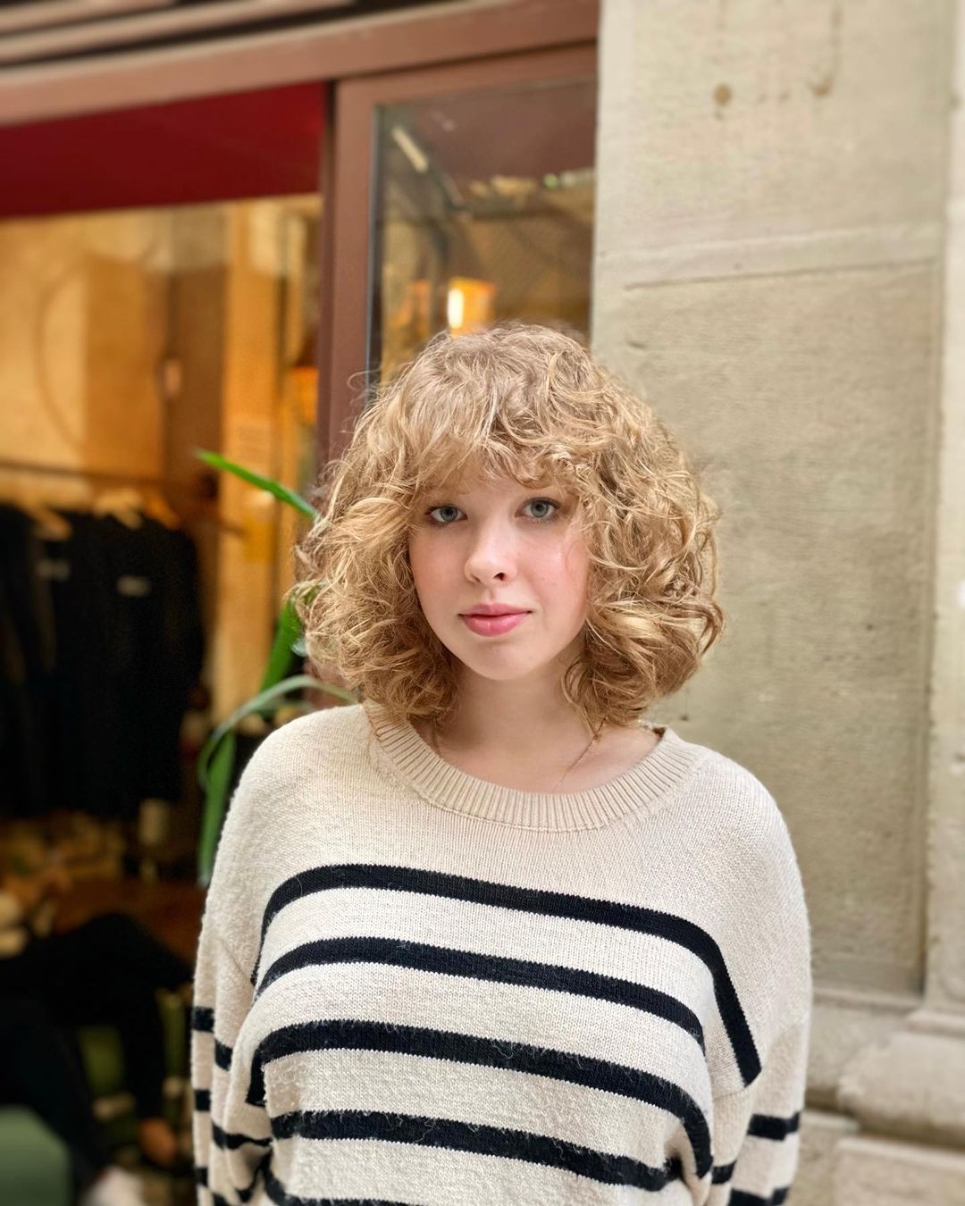 shoulder length curly bob with bangs