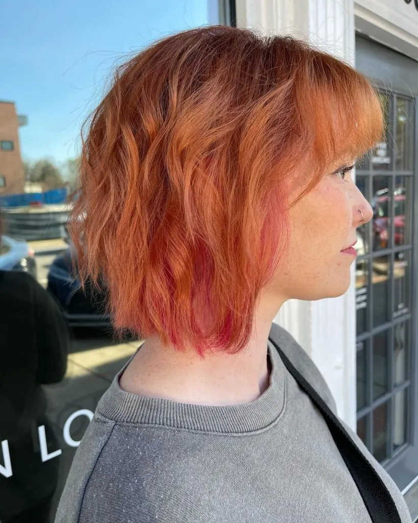 copper curly bob with bangs