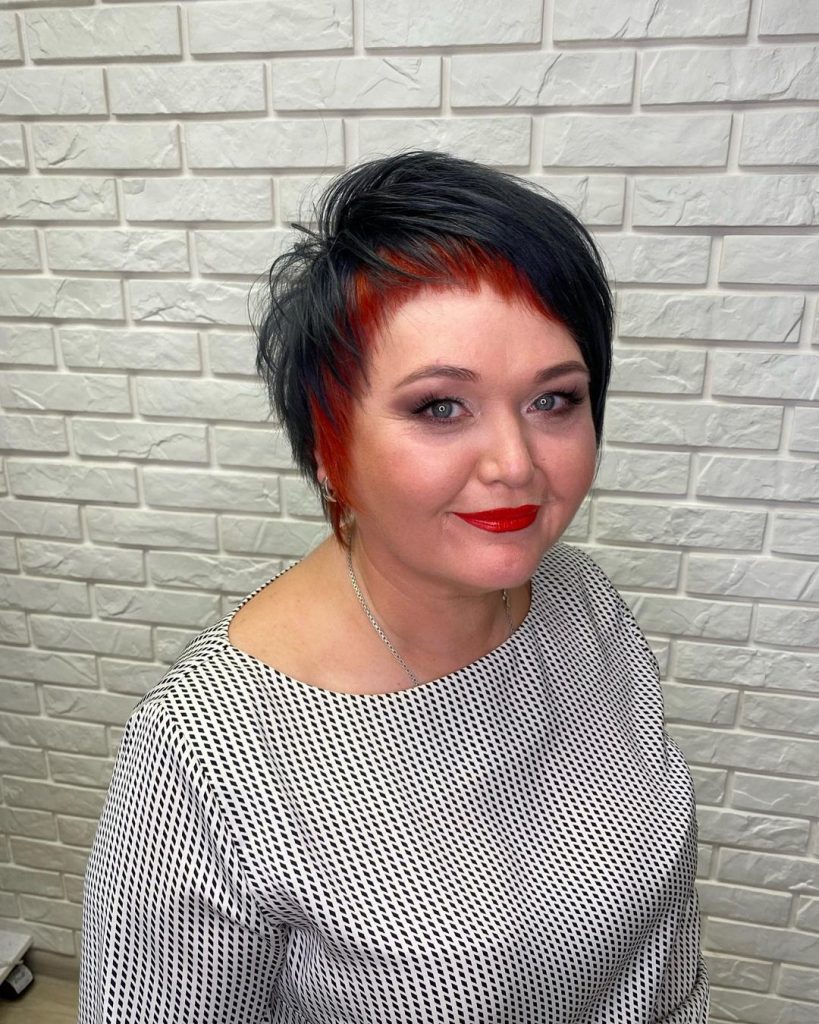 edgy short haircut with red lowlights for older women