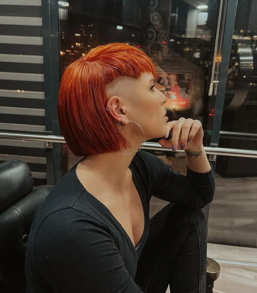 fiery red short hairstyle with edgy undercut for thick hair