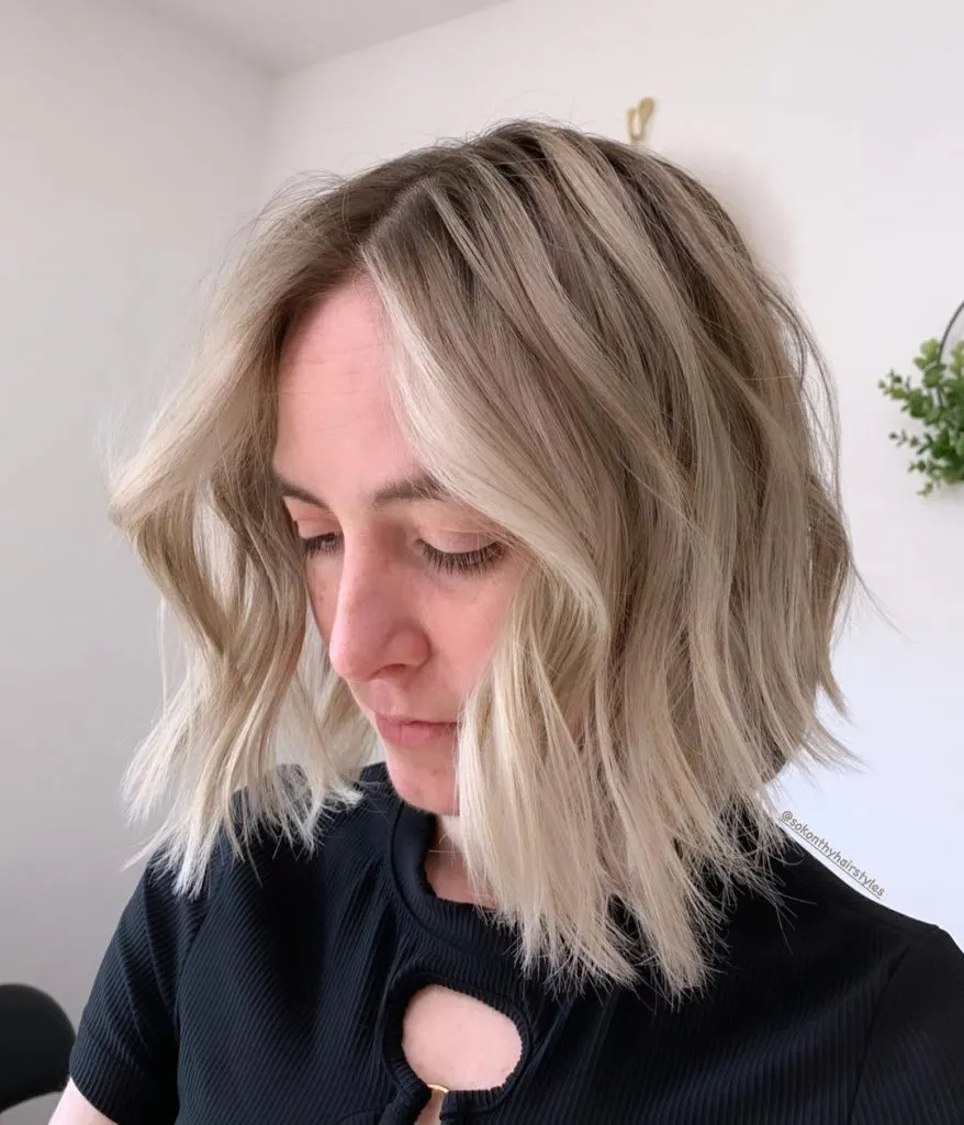 curly bob with ice blonde highlights for women over 40