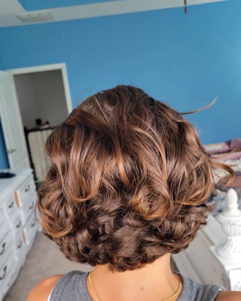 feathered curly bob for women over 50