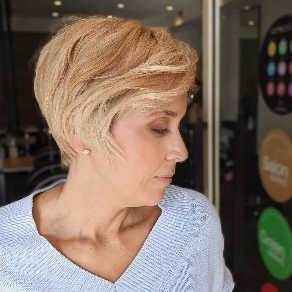 side swept short haircut with long bangs for women over 50