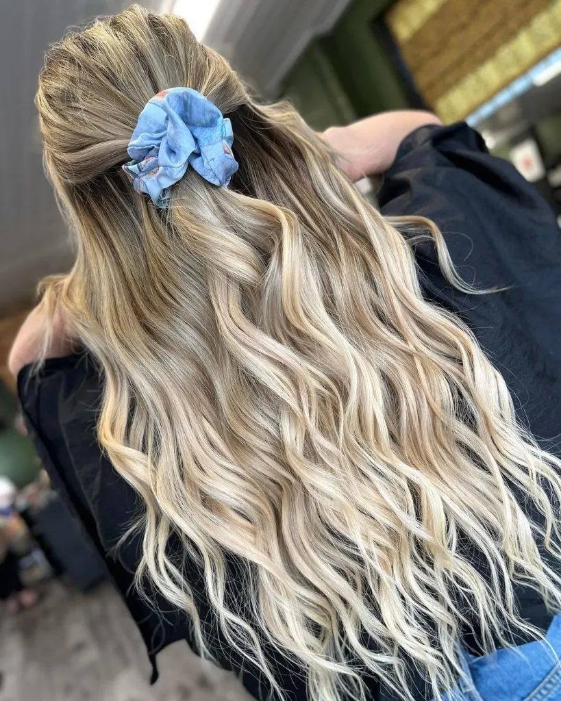blonde balayage topped with a scrunchie