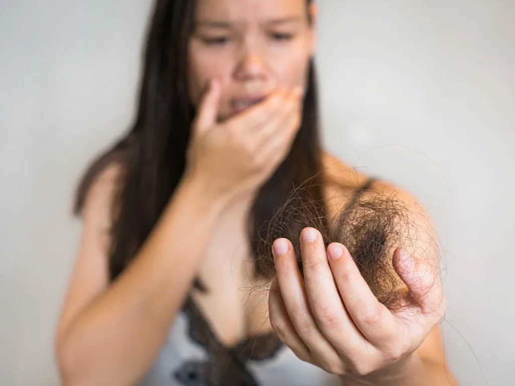 woman experiencing hair loss