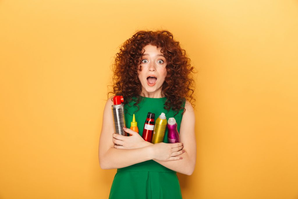 woman holding hair products 