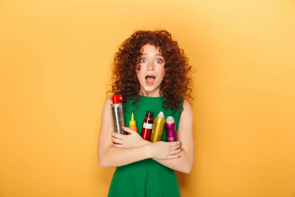woman holding hair products 