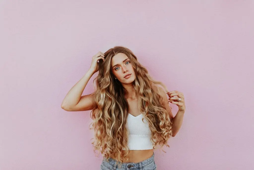 woman with long blonde curly hair