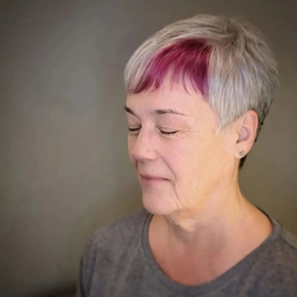 very short gray pixie haircut with pink bangs
