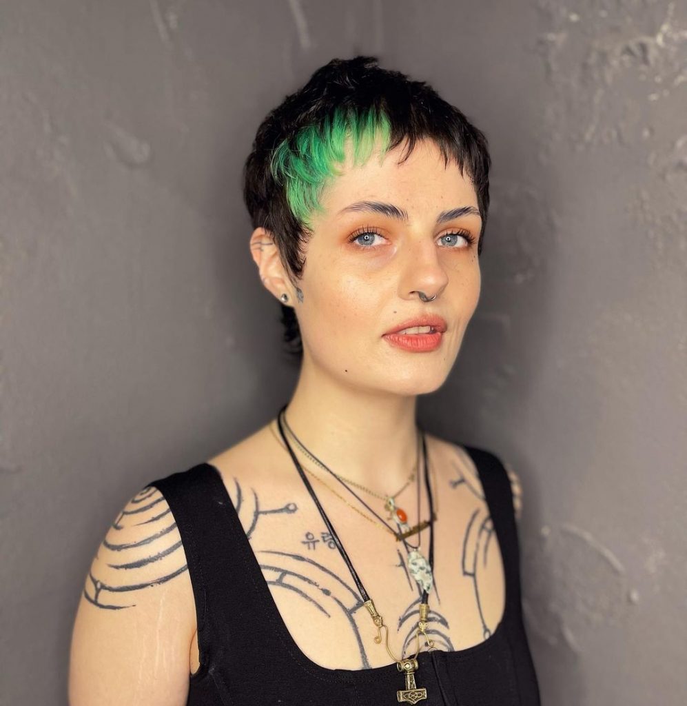 very short pixie haircut with green bangs