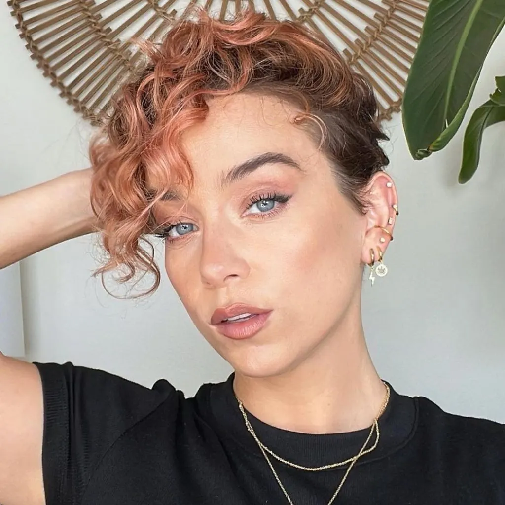 very short pixie haircut with long curly bangs