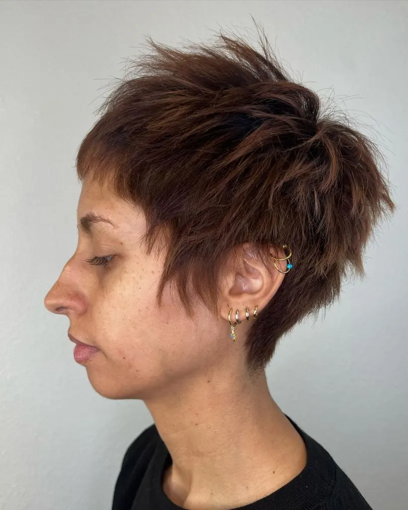 very short pixie haircut with longer sideburns