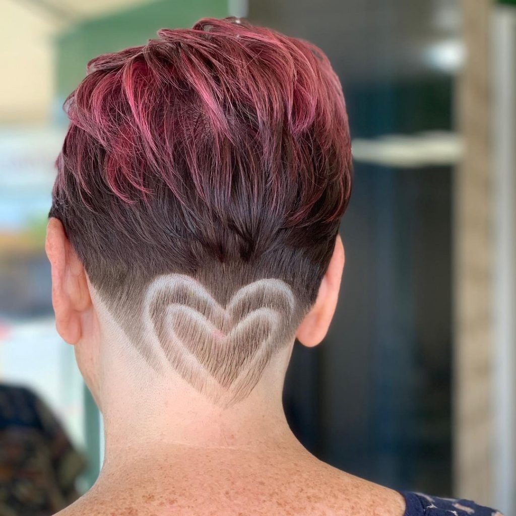 very short pixie haircut with tattooed neckline