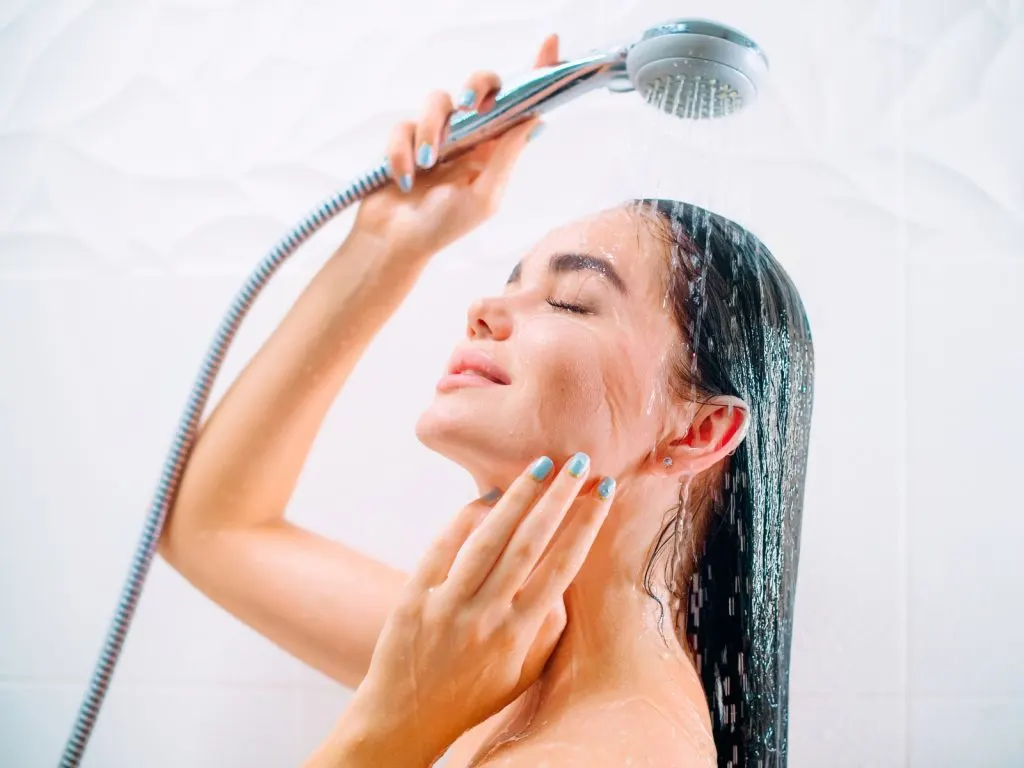 woman rinsing her hair