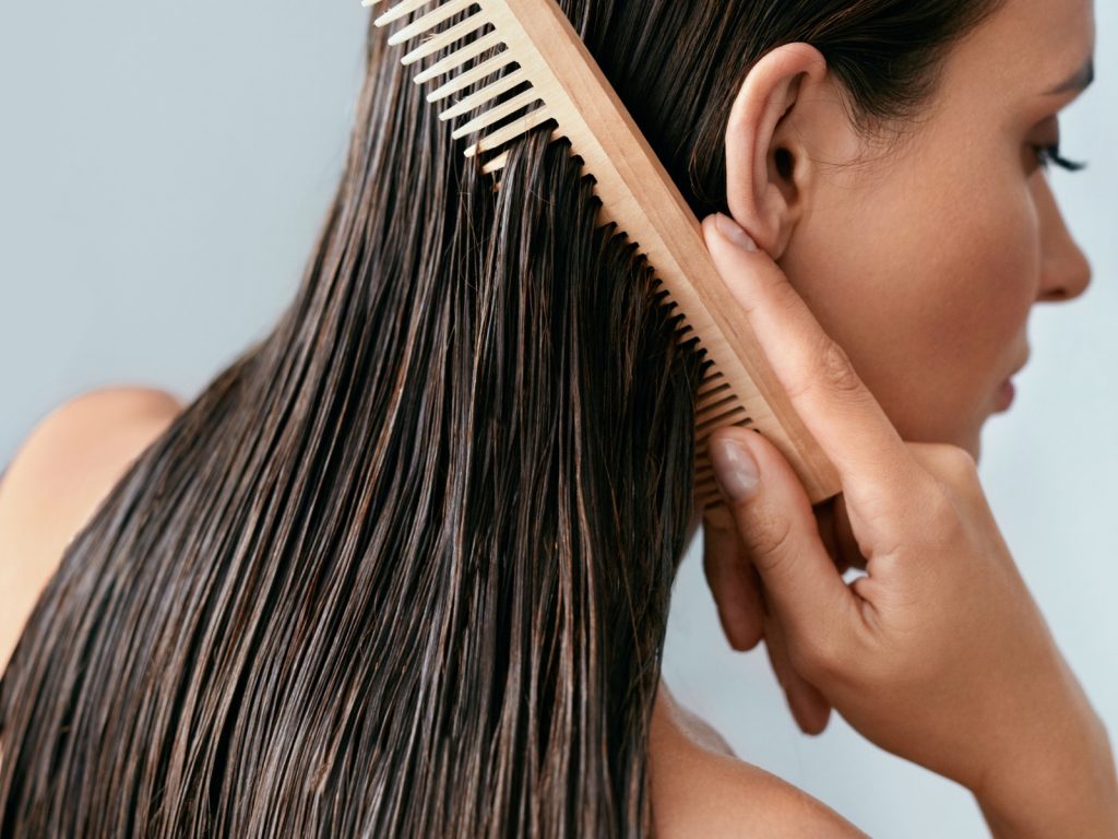 woman using wide-toothed comb