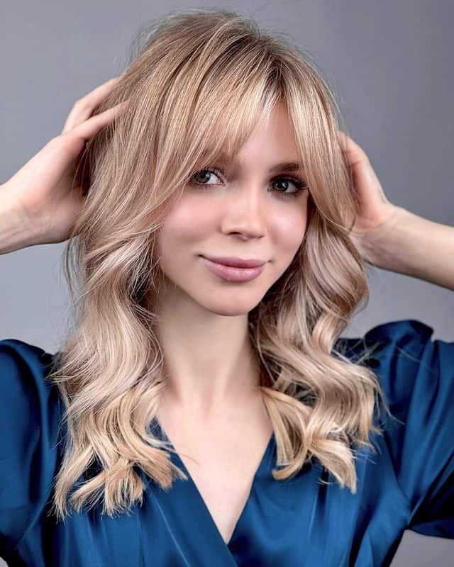 long curtain bangs on blonde balayage for round face