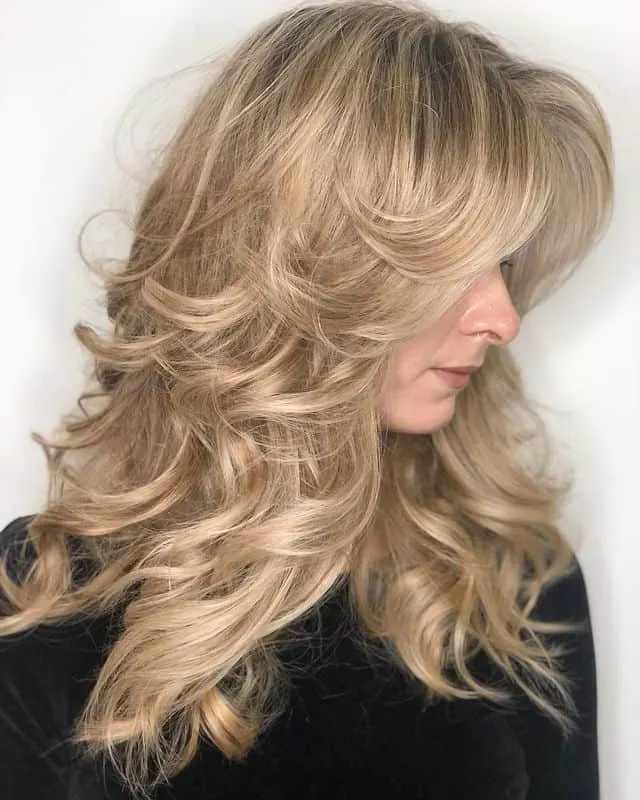 retro feathered hairstyle with bangs