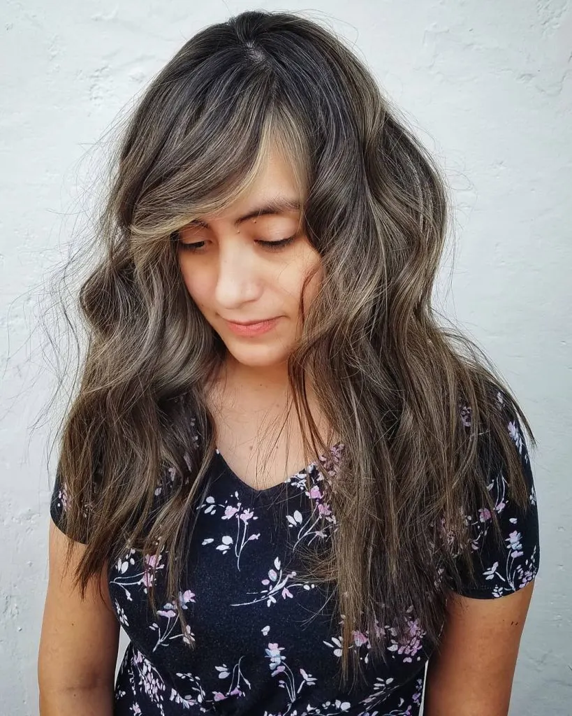 side bangs with rooted highlights and layers