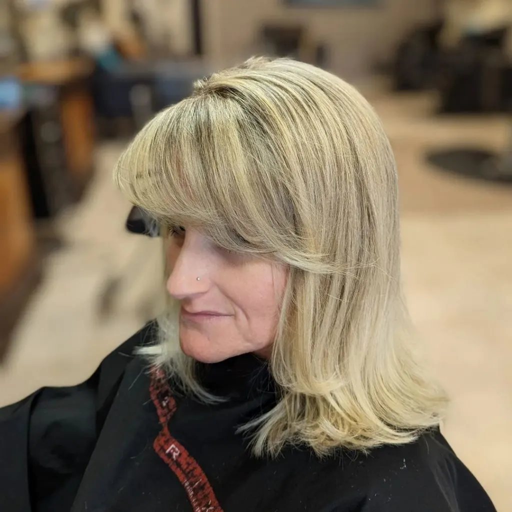 side swept bangs with long layers and highlights