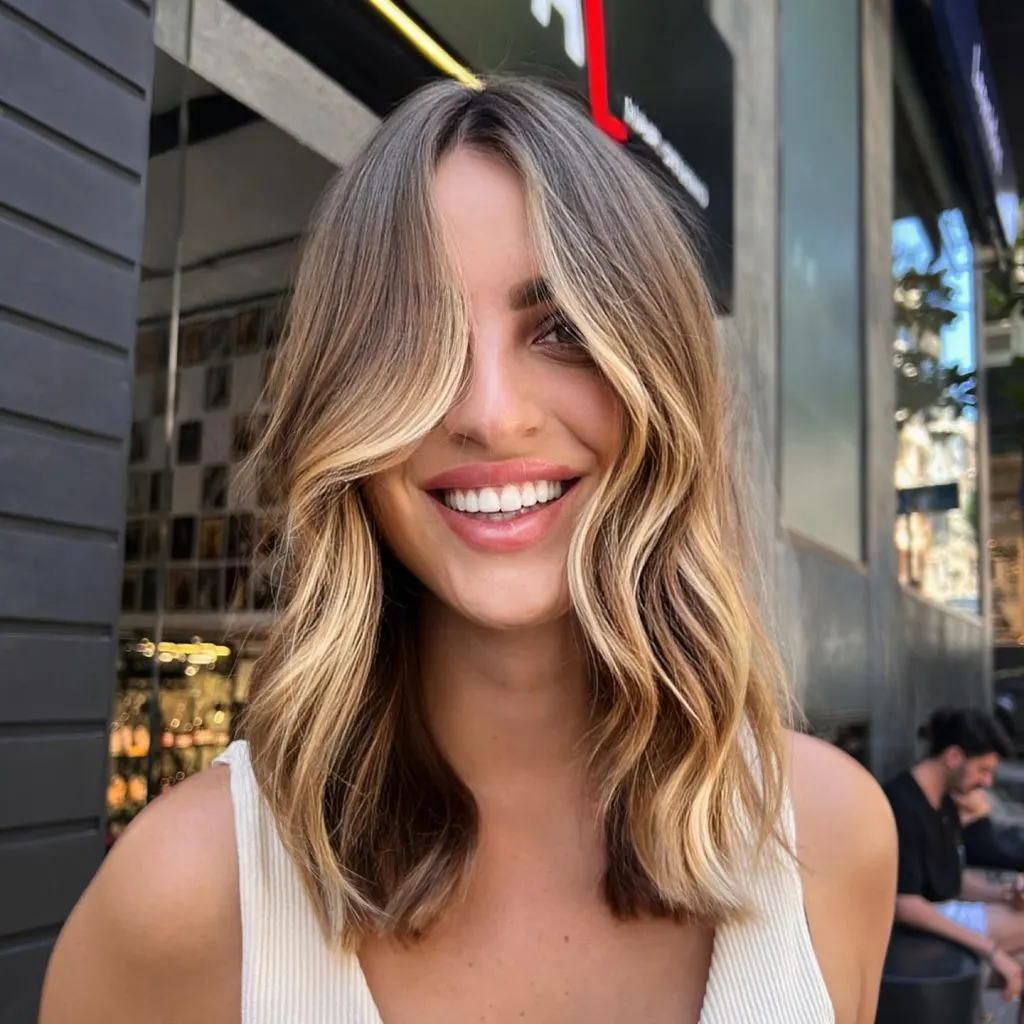 light brown hair with face-framing blonde highlights