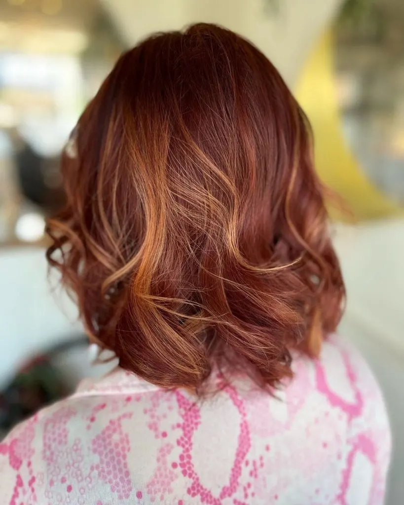 mahogany red with pops of blonde hair