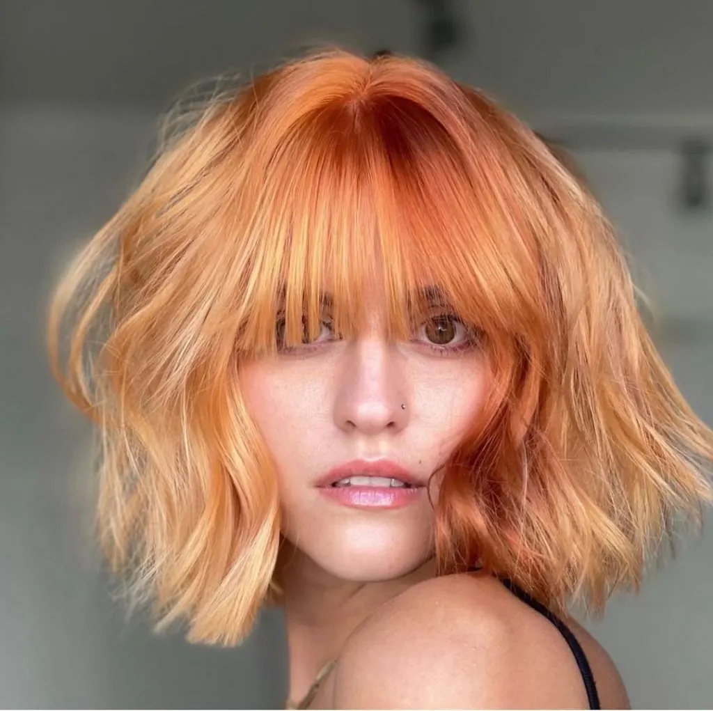 strawberry blonde french bob cut