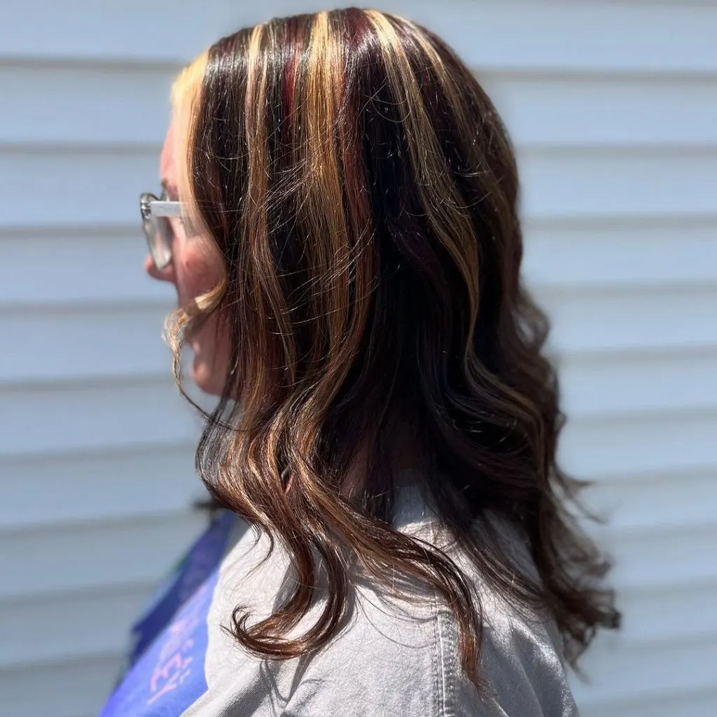 subtle red and blonde highlights on dark hair