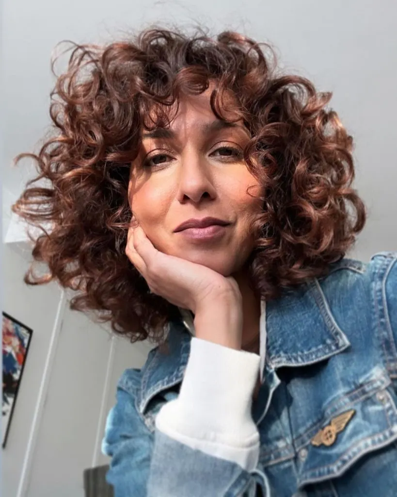 80's curly hairstyle with bangs