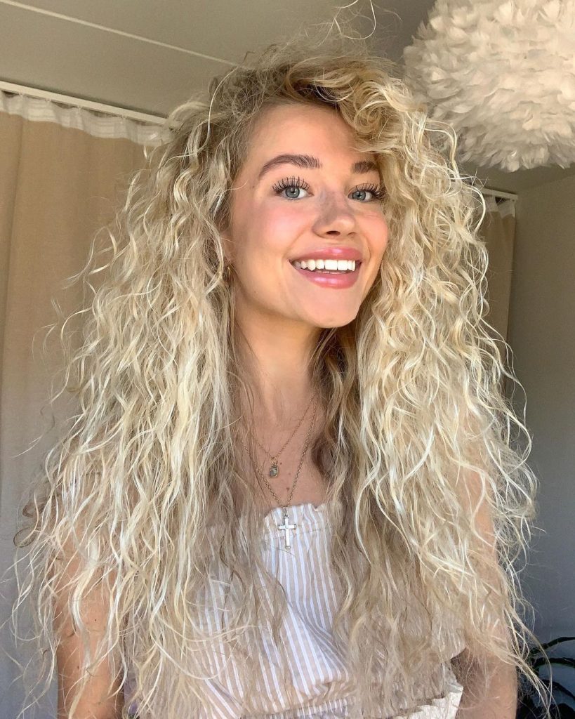 Blonde curly hair with bangs 
