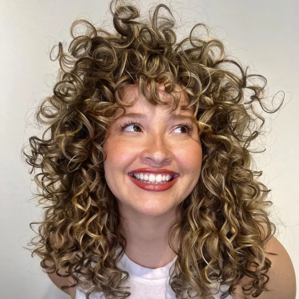 RëZOcut curly hair with bangs 

